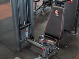 gym equipment in a gym with a red wall in the background