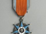 an image of a medal with a blue star on it