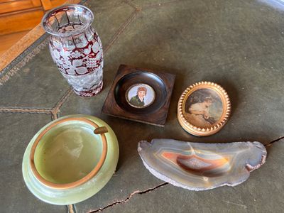 a picture of a glass, a bowl, and a picture of a man on a table