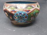 a vase with a colorful design on it sitting on a table