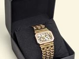 an image of a watch in a black box with a chain around it