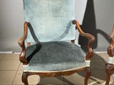 two chairs sitting next to each other on a tiled floor