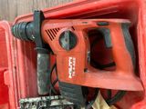 a red drill that is sitting in a red box