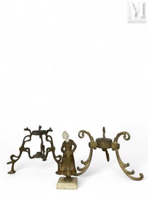 three antique brass candlesticks on a marble base