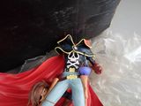 a figurine of a pirate with a red cape