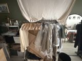 a pile of clothes on a cart in a room