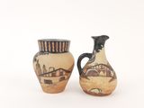 two vases with designs on them on a white surface