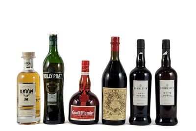 several bottles of alcohol are lined up on a white surface