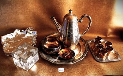 a silver plate with a silver tea pot and a silver tray with chocolates on it