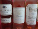 several bottles of wine are lined up in a row on a table