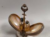 a small shell with a bird on top of it