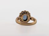 an image of a gold ring with a blue stone in the center