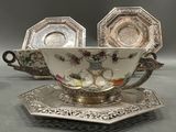 two cups and saucers are sitting on a tray on a table