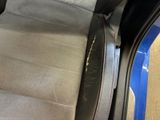 the back seat of a car with a seat belt in it