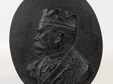 a close up of a black stone plaque with a man in a hat