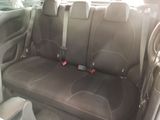 four seats in the back of a car that are black