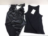 two women ' s black lingersuits on a white table with a price tag