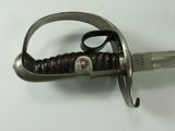 a close up of a sword on a white surface