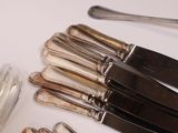 a lot of forks and spoons on the table