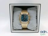 an image of a gold watch with a blue dial in a box