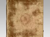 an old book with a brown cover sitting on top of a table