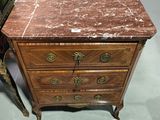 a marble top chest of drawers on display in a store