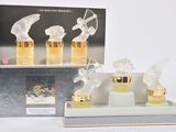 a box with three perfume bottles and a box with two angel figurines on it