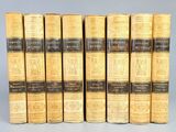 a set of six books with gold covers and black bindings