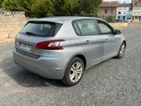 a silver car that is parked on the side of the road