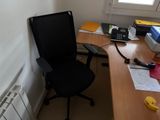 a desk with a chair and a phone on it