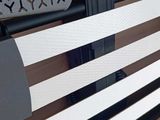 a white bench with black and white stripes on it