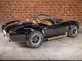 a black sports car parked in front of a brick wall