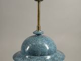 an image of a blue vase with a brass base
