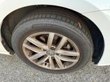 a close up of a tire on a white car