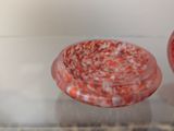 two red bowls sitting on top of a marble table