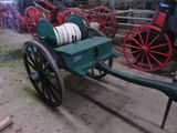 a green wagon with a white wheel and a red wagon behind it