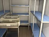 a small room with shelves and a sink in it