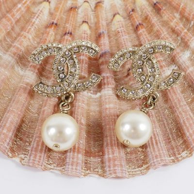 chanel pearl and diamond earrings on a seashell