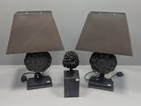 two lamps that are sitting on a table
