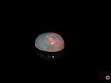 an image of a white fire opal in the dark
