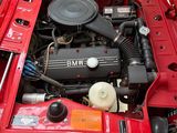 a red bmw engine in the trunk of a red car