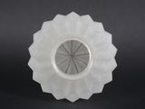 a close up of a white glass vase with a circular design