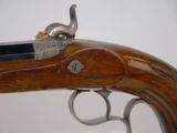 an old gun with a wooden handle on a white background