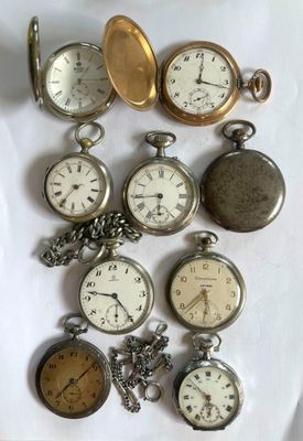 many different types of pocket watches on the table