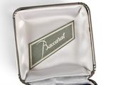 a silver case with a blue ribbon in it