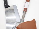 a close up of a pair of knives and a leather sheath