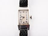 a watch that is sitting on a white surface