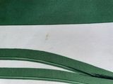a close up of a piece of paper with green strips