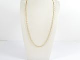 a white mannequin with a gold chain on it
