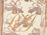 a close up of a glass block with a gold monogram on it